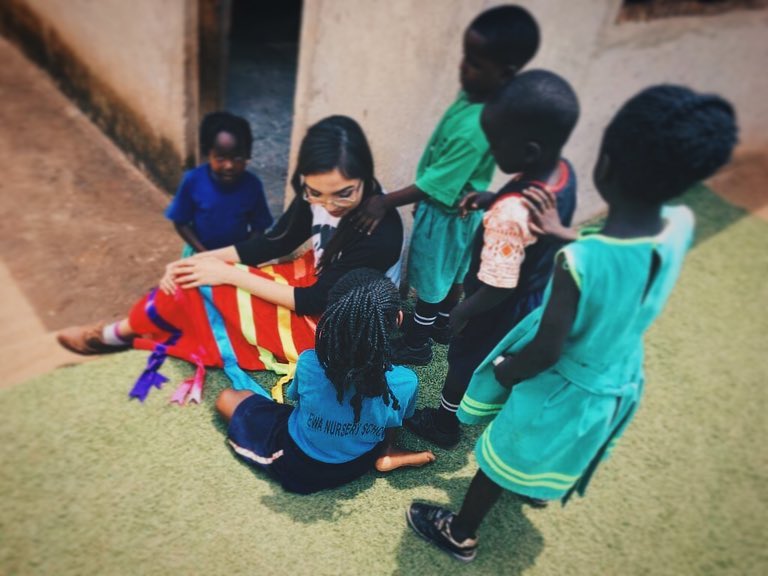 volunteers Savanna Sparvier teaching children.